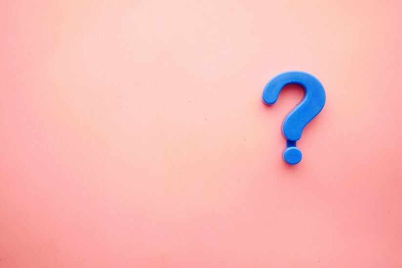 Blue question mark displayed on a pink background